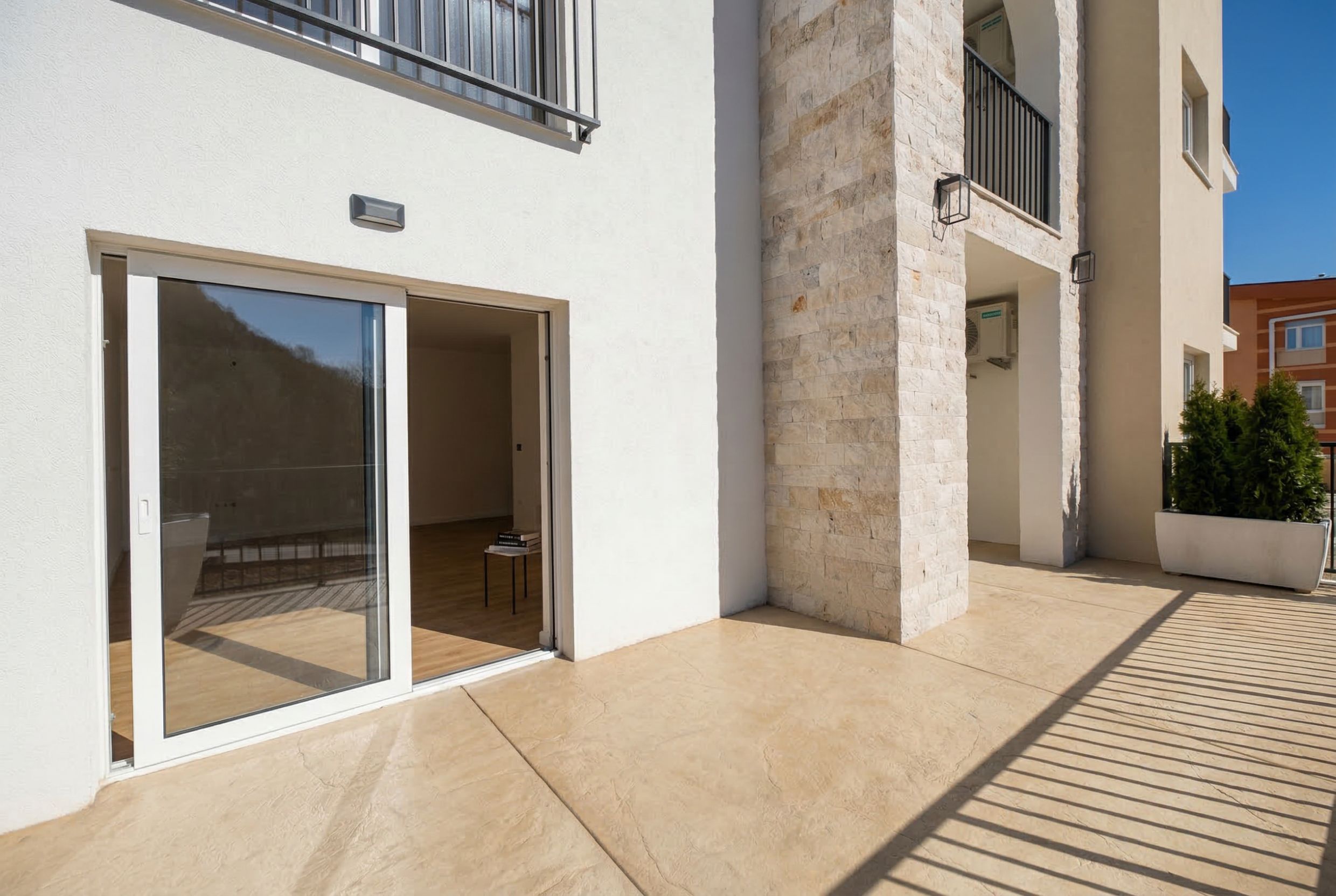 Spacious terrace with stone finishes and panoramic access to the apartment in Sutomore, Montenegro.
