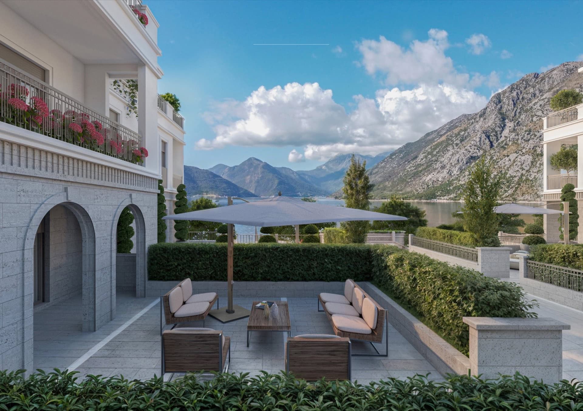 Terrace with garden furniture in a luxury residential complex in Ljuta, Montenegro, overlooking the Bay of Kotor and the mountains.