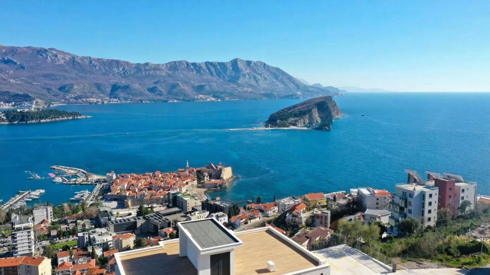 Panoramic view of Budva, St. Nicholas Island, and the Adriatic Sea from the terrace of a villa in Montenegro.
