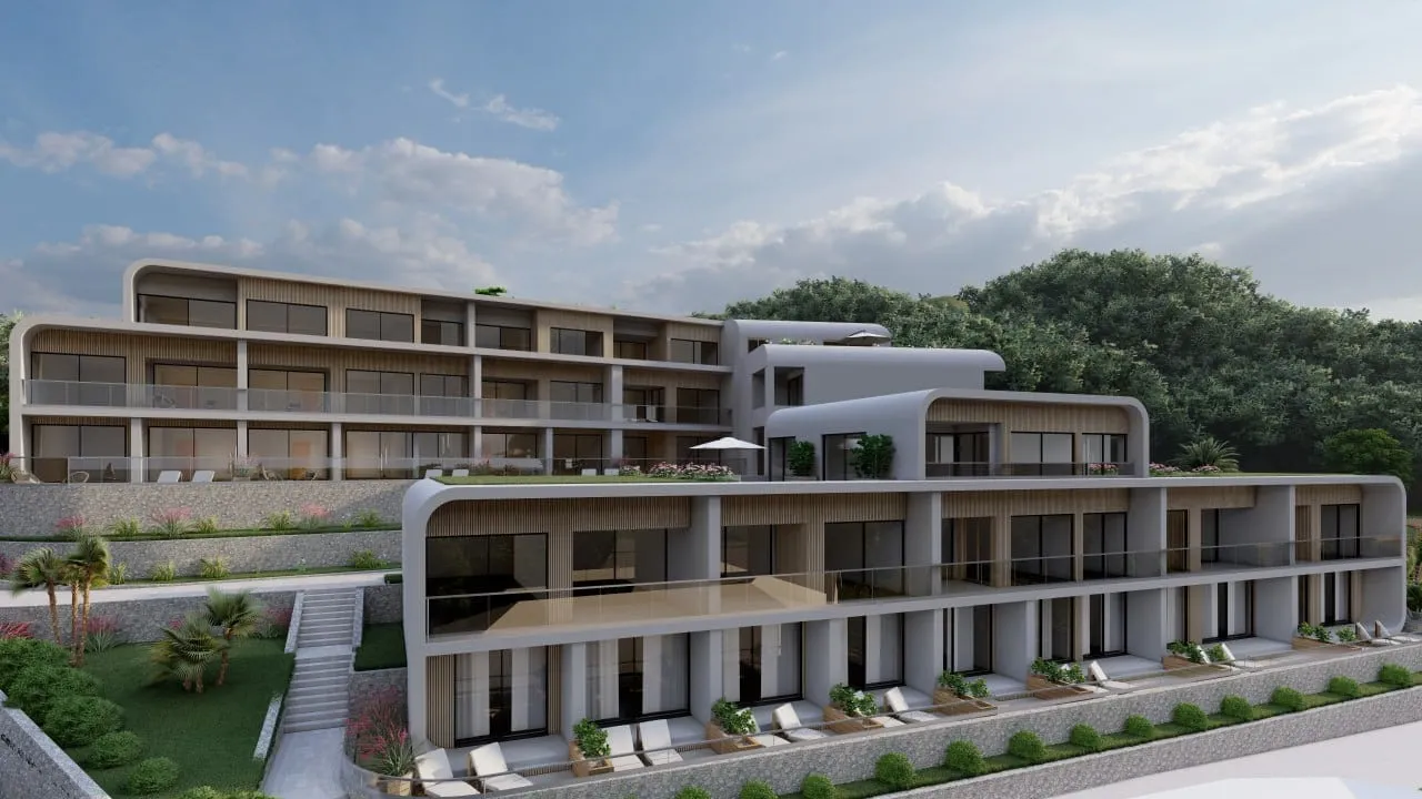 Modern multi-story residential complex with balconies, terraces, and landscaping against a forest backdrop.