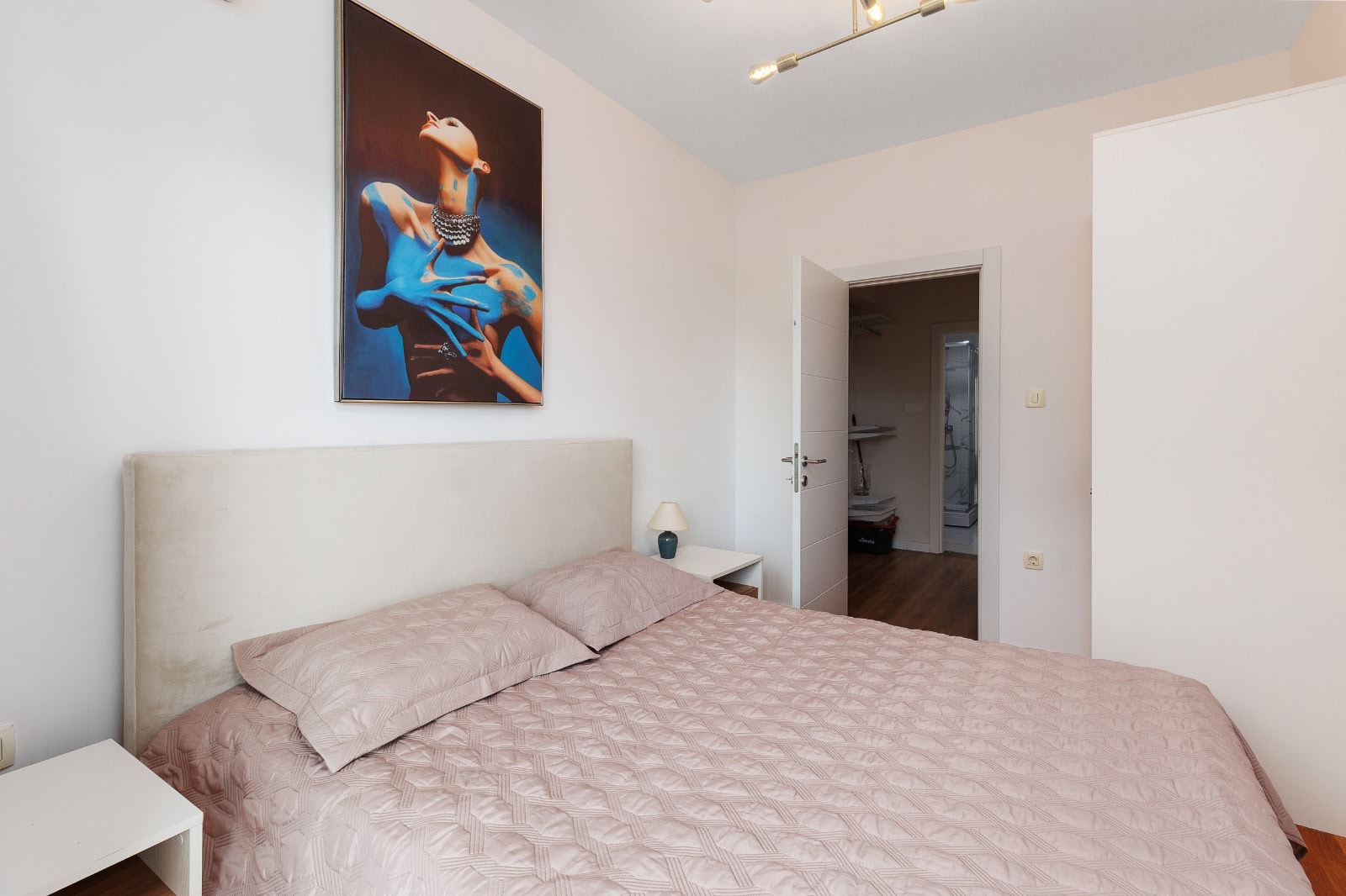 Bright bedroom with a double bed in an apartment in Bečići, Montenegro: modern finishes and stylish decor.
