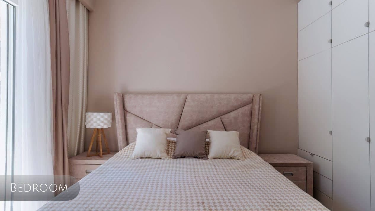 Cozy bedroom in an apartment in Orahovac, Montenegro: a double bed with a soft headboard and a built-in wardrobe.