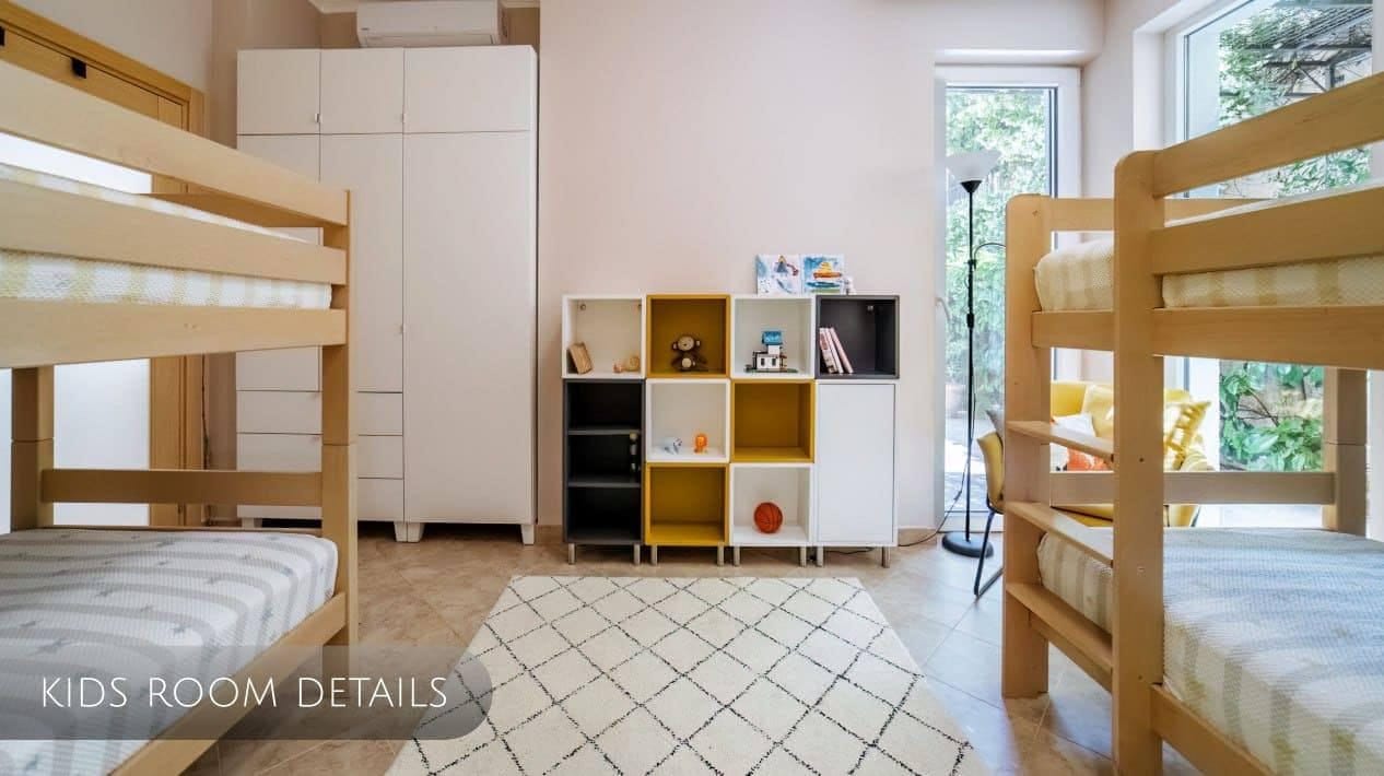 Children’s bedroom with two bunk beds and a shelving unit in an apartment, Orahovac, Montenegro.