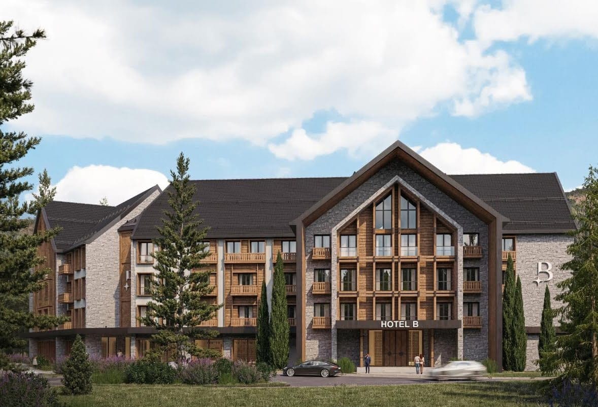 Modern chalet-style hotel with stone and wood finishes in Kolasin, Montenegro, front view of the building.