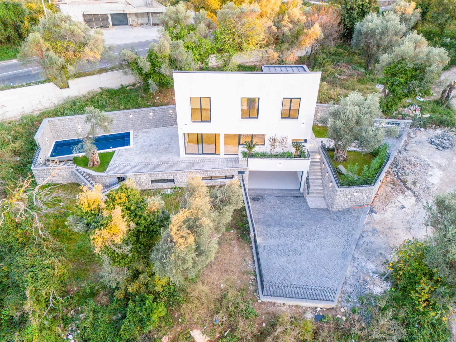 Modern villa in Kamenovo, Montenegro: aerial view of the house with pool, terrace, garden, and parking.