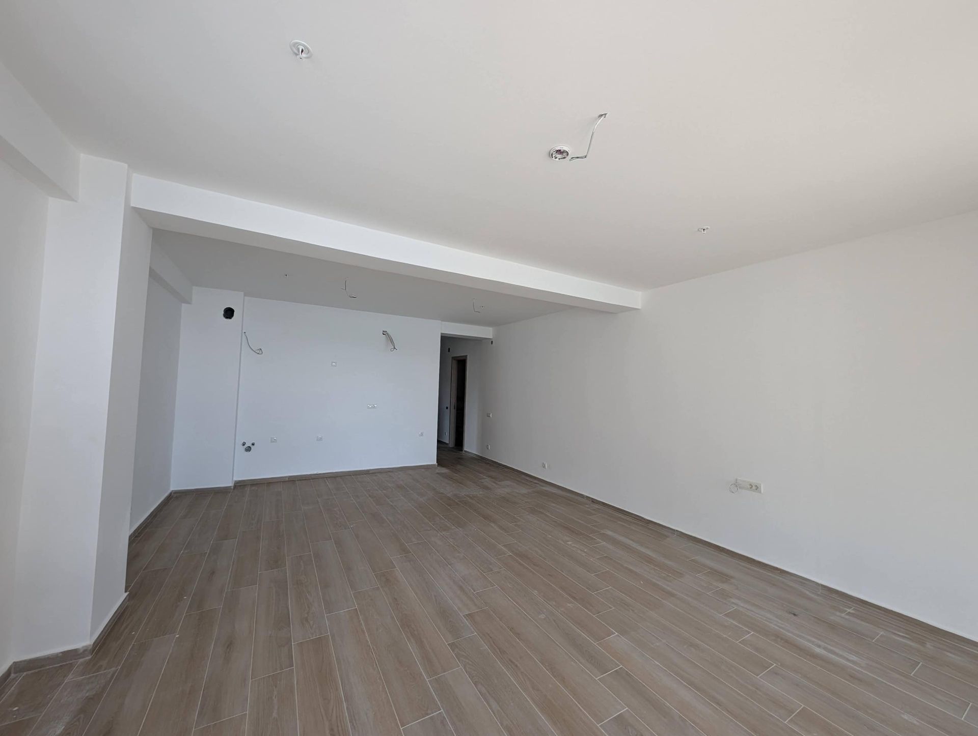 Spacious living room with finished finishes and light walls in a new construction apartment in Rafailovici, Montenegro