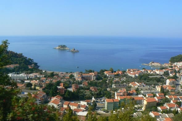 Panoramic view of the sea and the city of Petrovac in Montenegro with the island of Katic in the background of resort development.