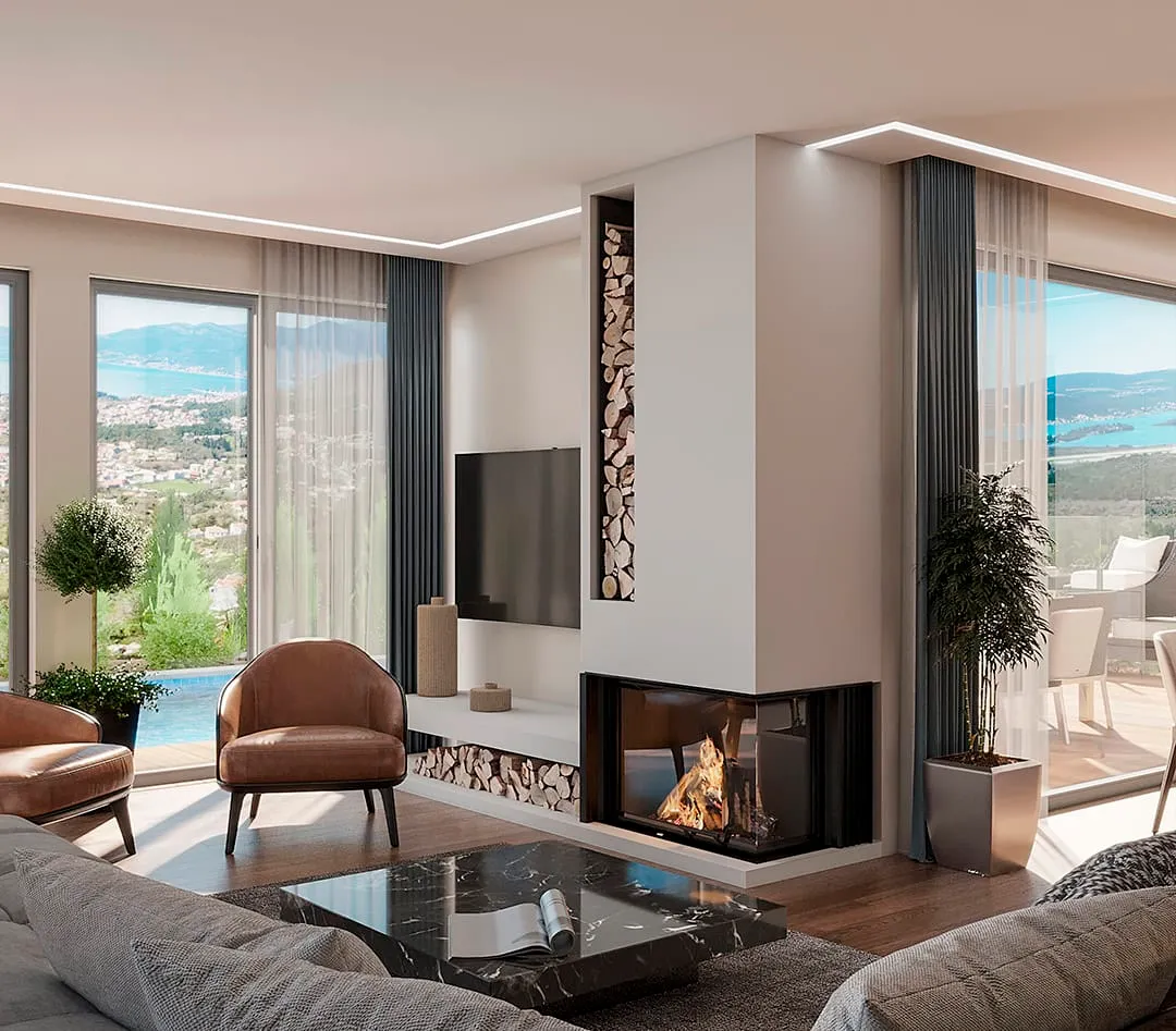Modern living room featuring a fireplace, sofa, leather chairs, and large windows overlooking the sea.