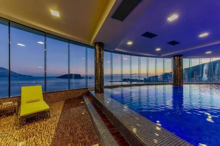 Indoor pool with panoramic sea and island views in a luxury residential complex, Budva, Montenegro.