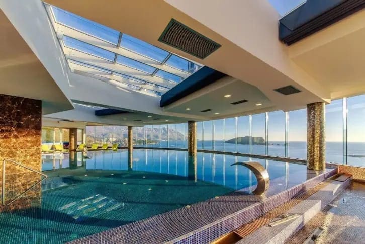 Indoor pool with panoramic sea and island views in a luxury residential complex, Budva, Montenegro.