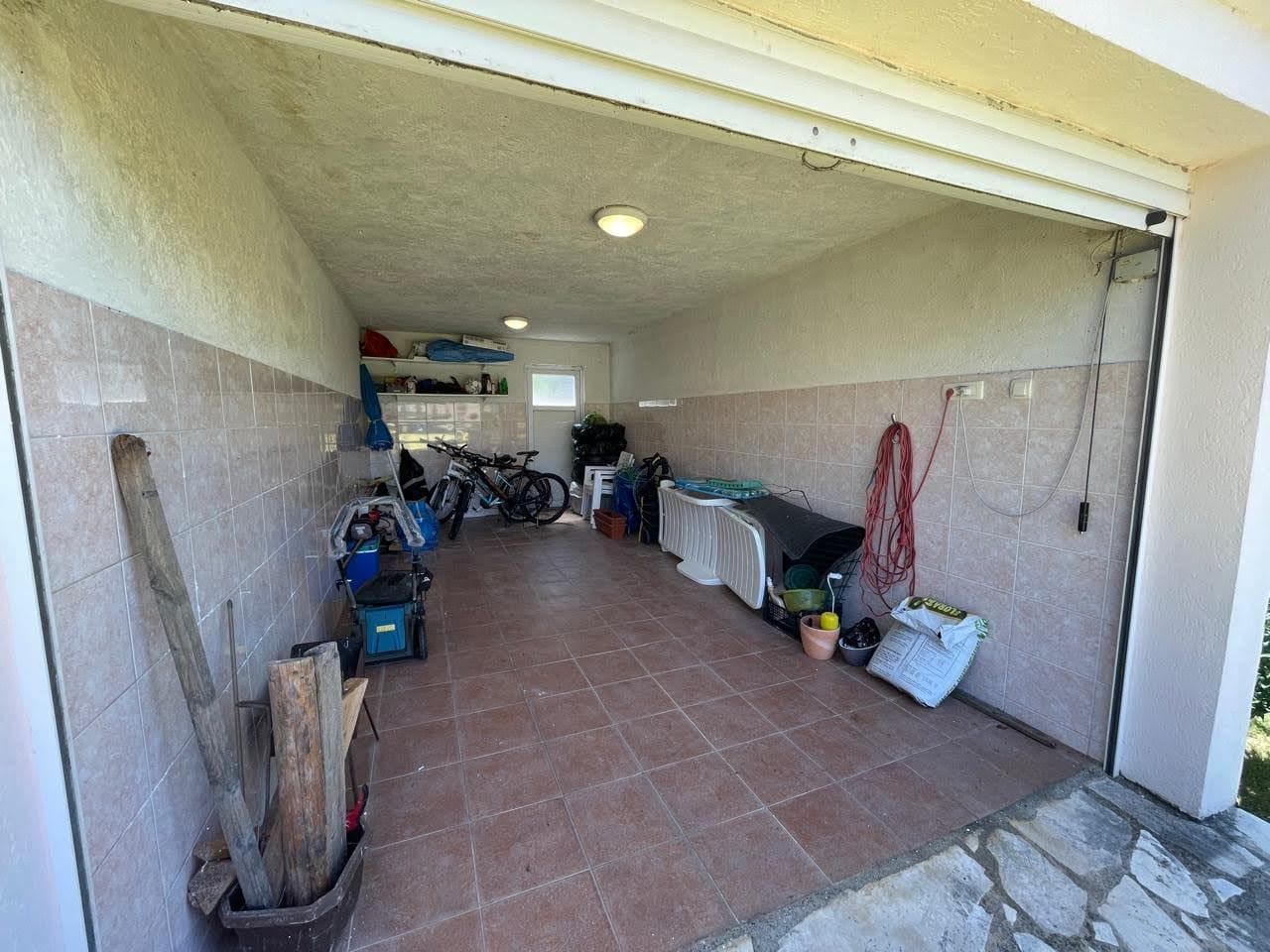 Spacious garage with tiled walls and floor in a private house, Bar, Montenegro.