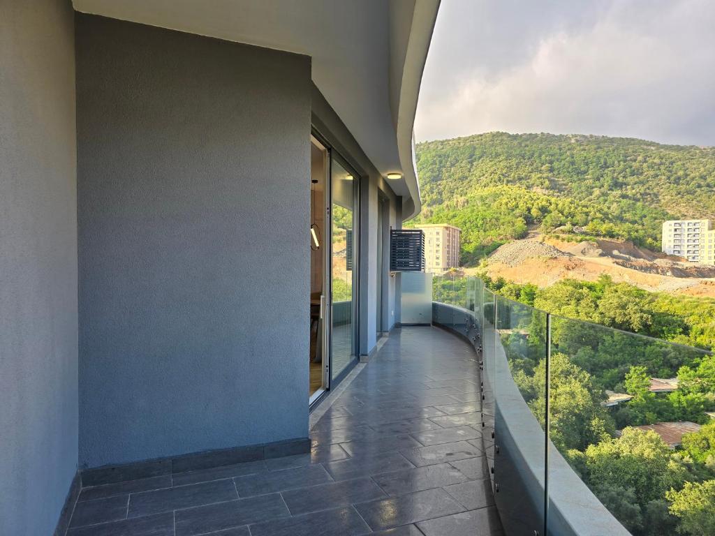 Spacious balcony with panoramic glazing and mountain views in an apartment, Becici, Montenegro.