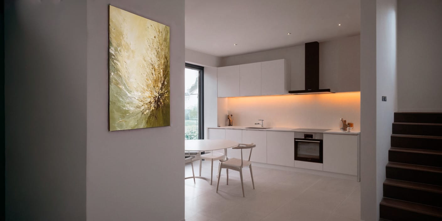 Modern kitchen in a townhouse in Blizikuće, Montenegro: white cabinetry, dining area, and stylish wall art.