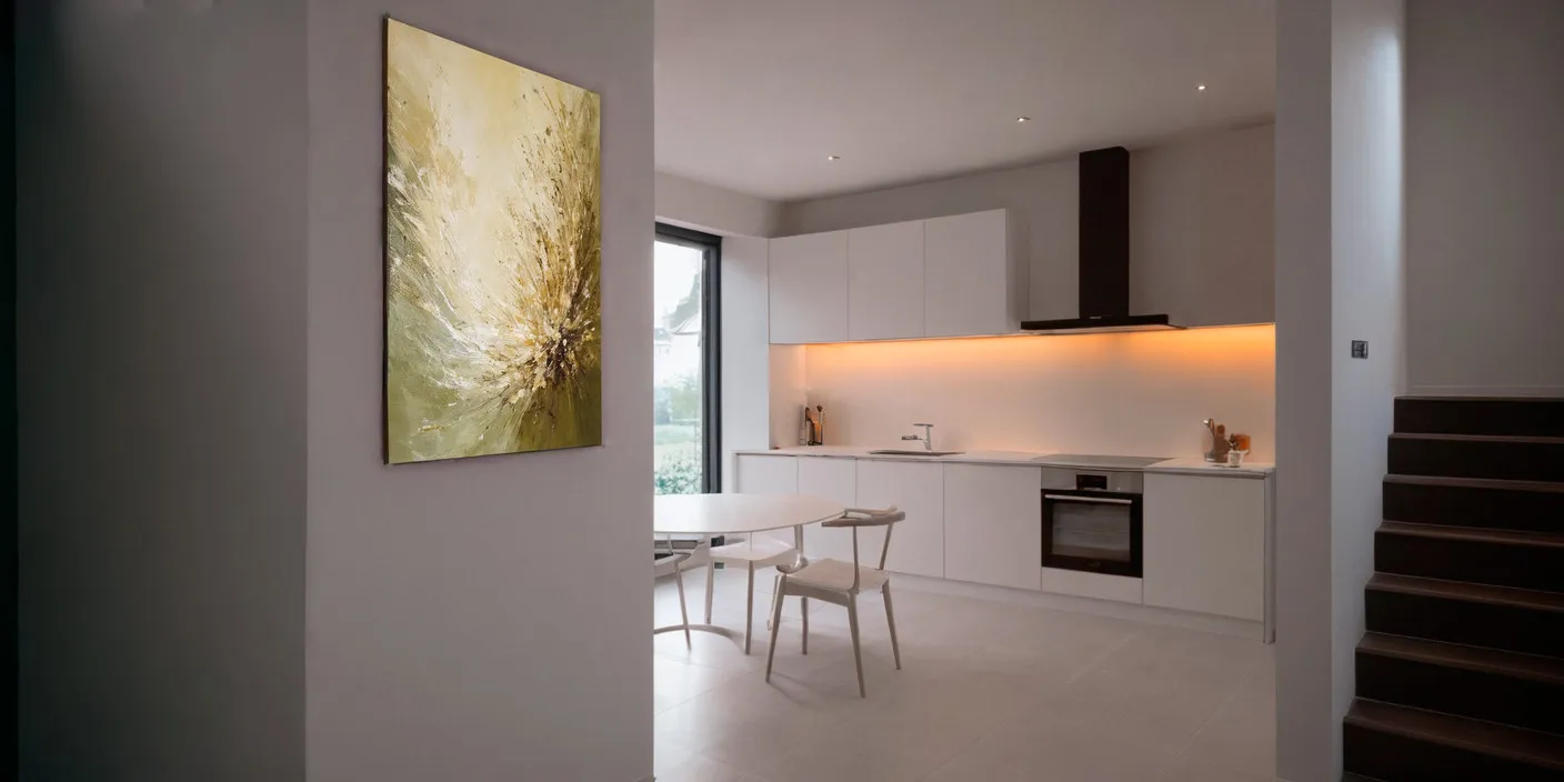 Modern kitchen with white cabinets, black hood, built-in oven, and a dining table visible in the foreground.