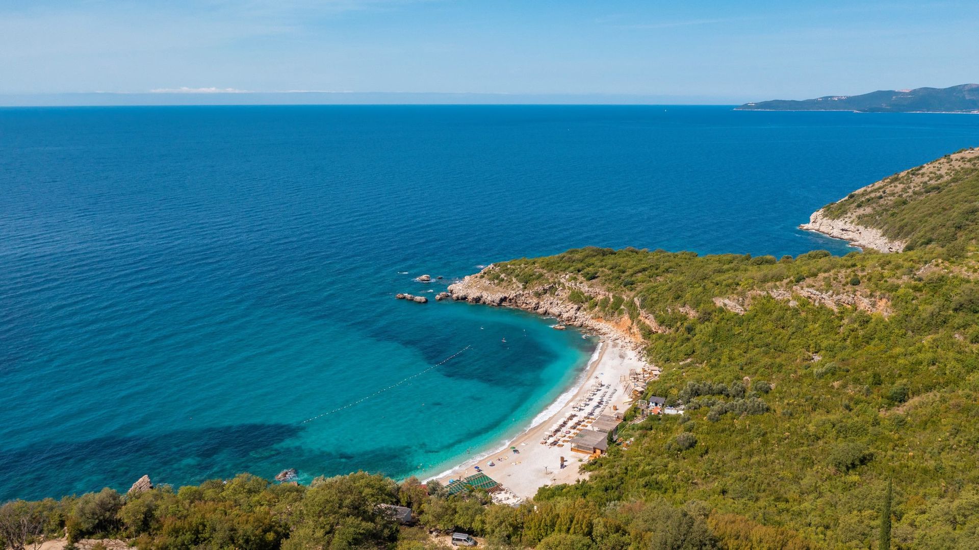 Aerial view of a picturesque beach and the Adriatic Sea in Reževići, Montenegro, near the property.