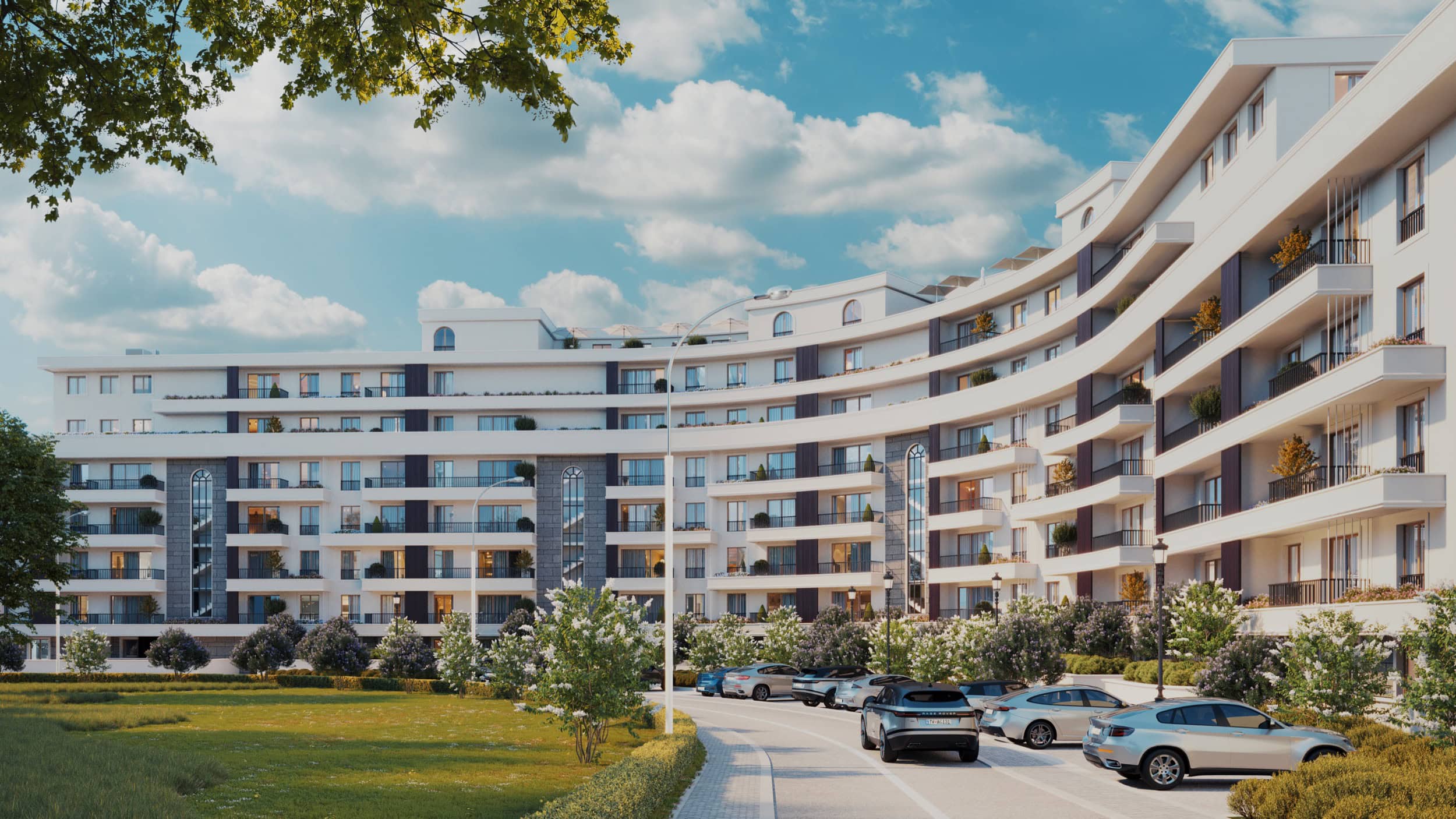 Modern residential complex in Bečići, Montenegro: building facade with balconies, parking, and landscaped grounds.