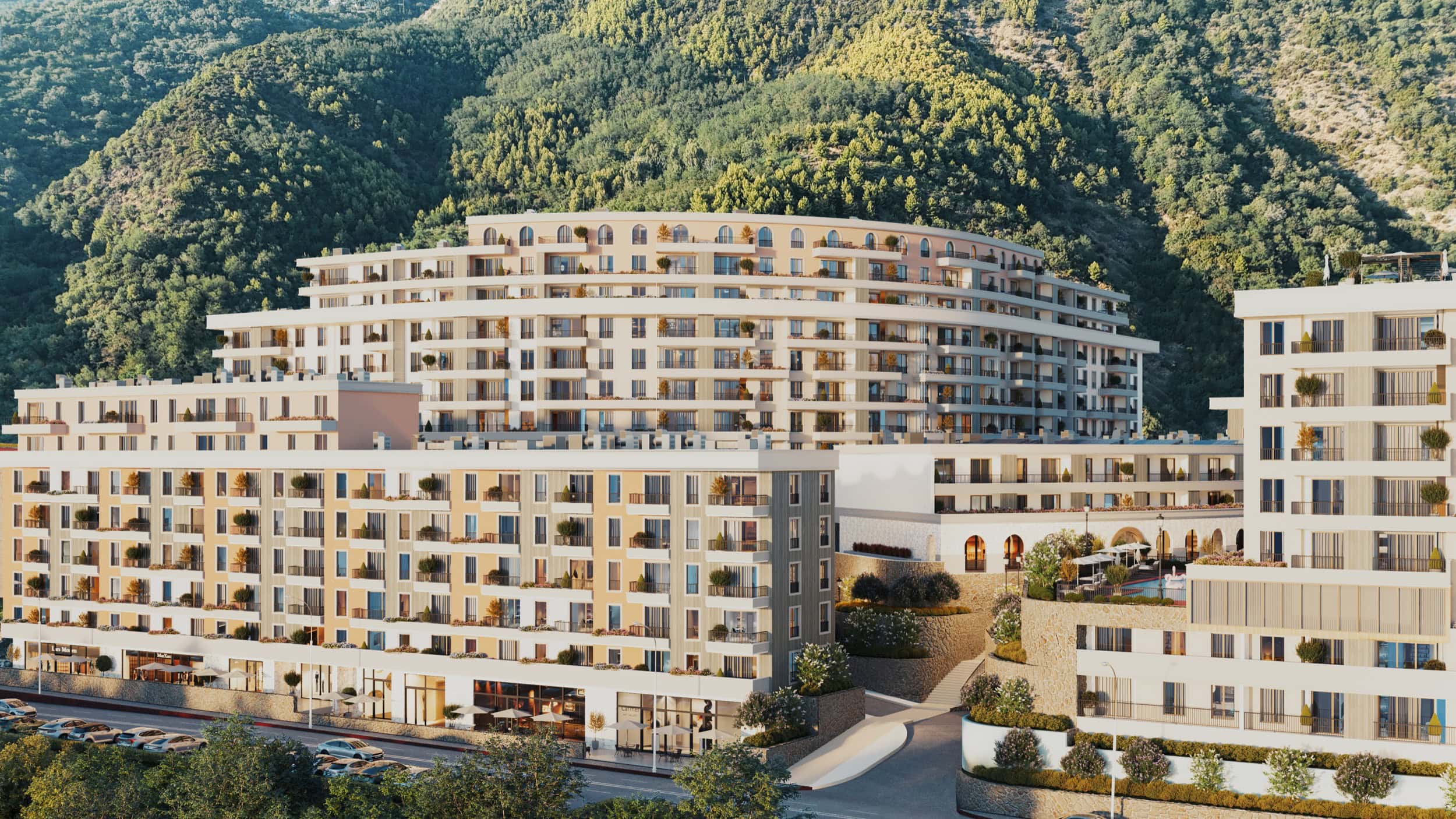 Modern residential complex in Bečići, Montenegro: multi-level buildings with terraces against a scenic mountain backdrop.