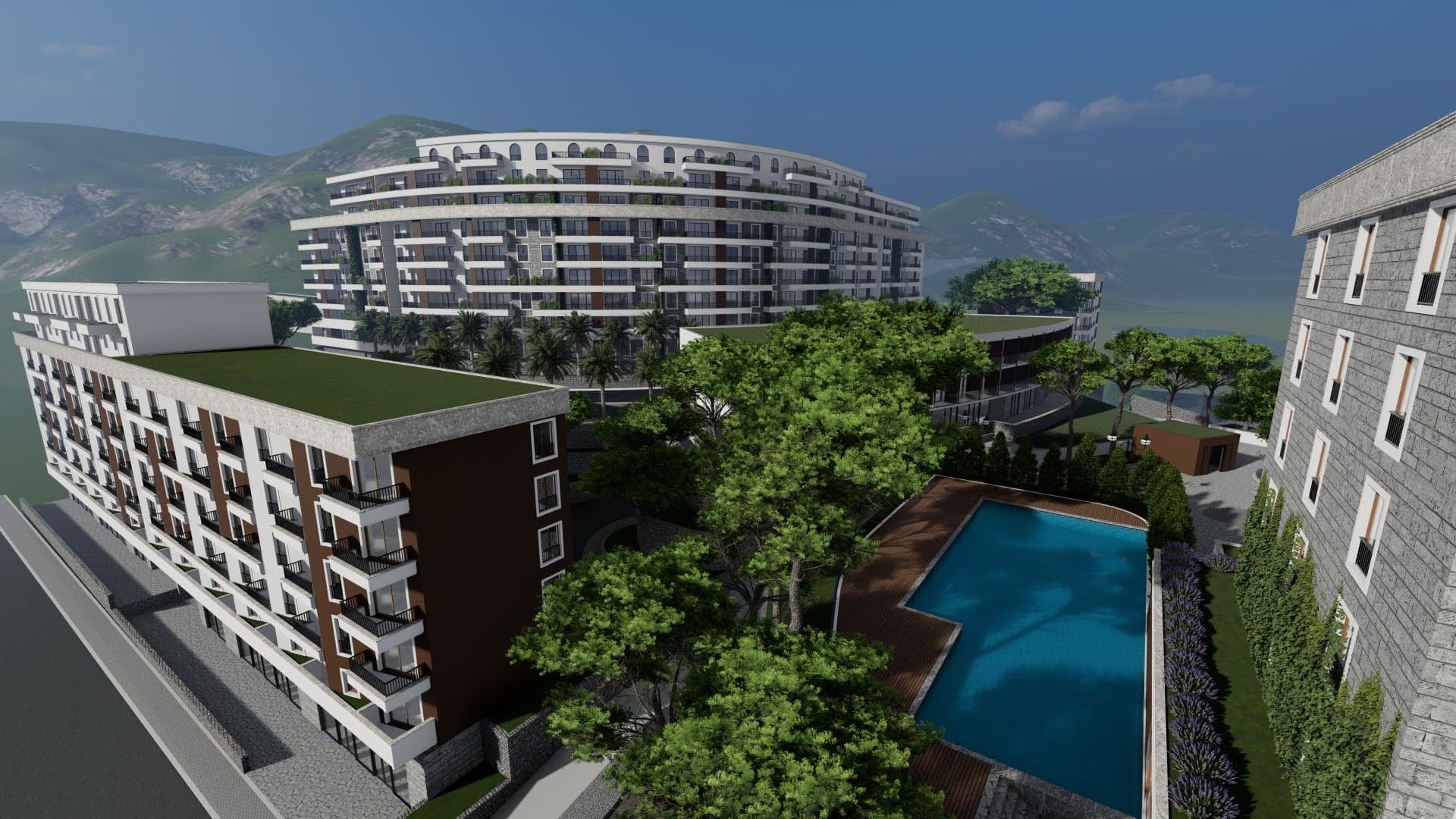 Top view of a modern residential complex with a pool and green terraces in Bečići, Montenegro.
