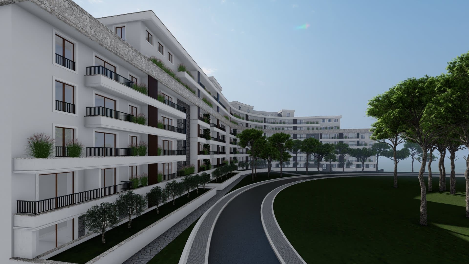 Modern residential complex in Bečići, Montenegro: building facade with terraces, landscaping, and surrounding grounds.