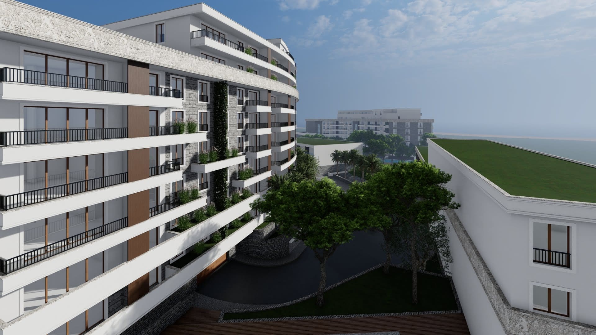 Modern residential complex with terraces and landscaping in Bečići, Montenegro: view of the building and surrounding area.