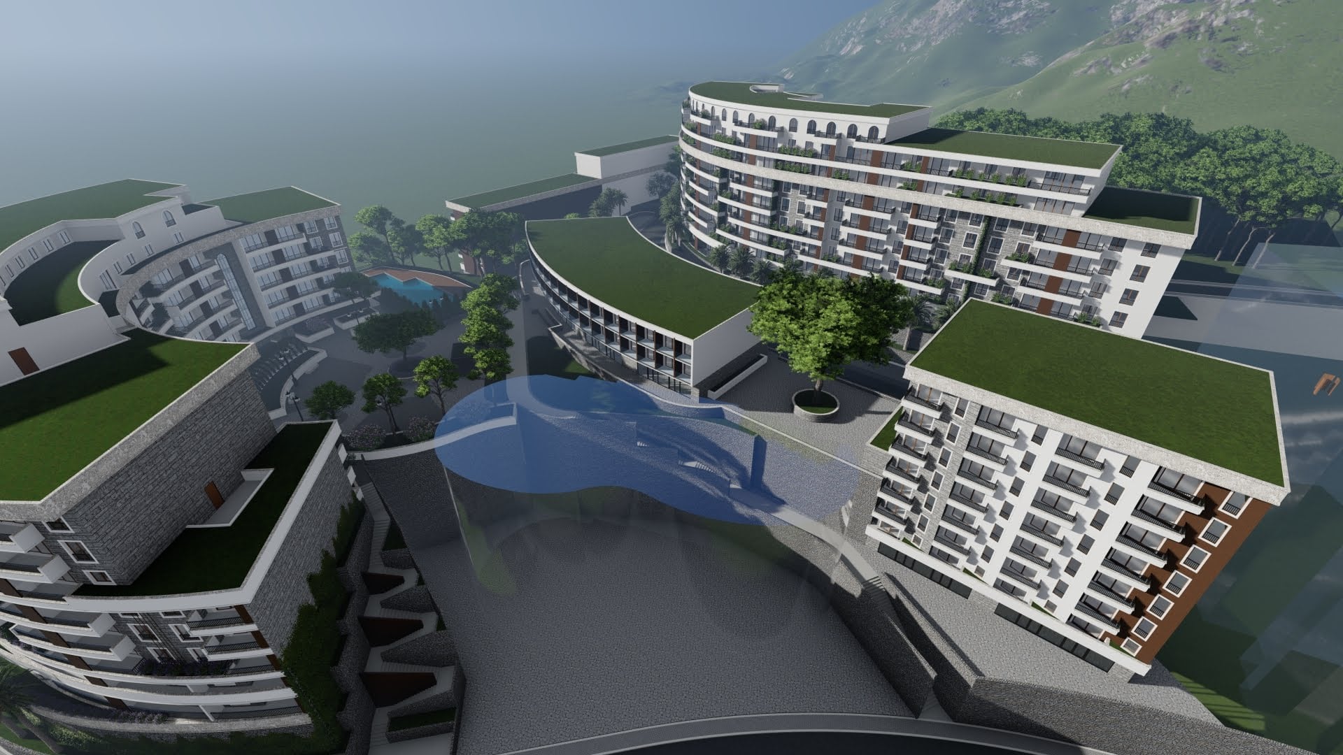 Aerial view of a modern residential complex in Becici, Montenegro: multi-story buildings, green roofs, and a swimming pool.