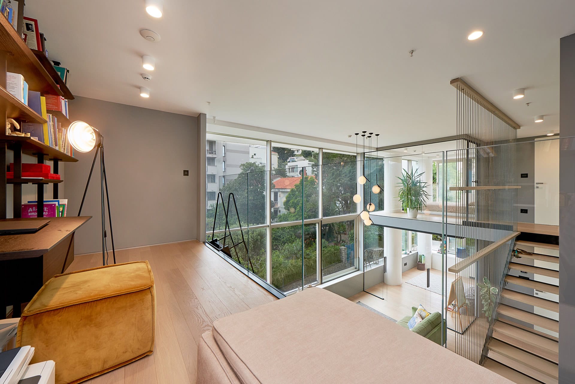 Modern two-level apartment in Budva, Montenegro: stylish living room with panoramic windows and staircase.