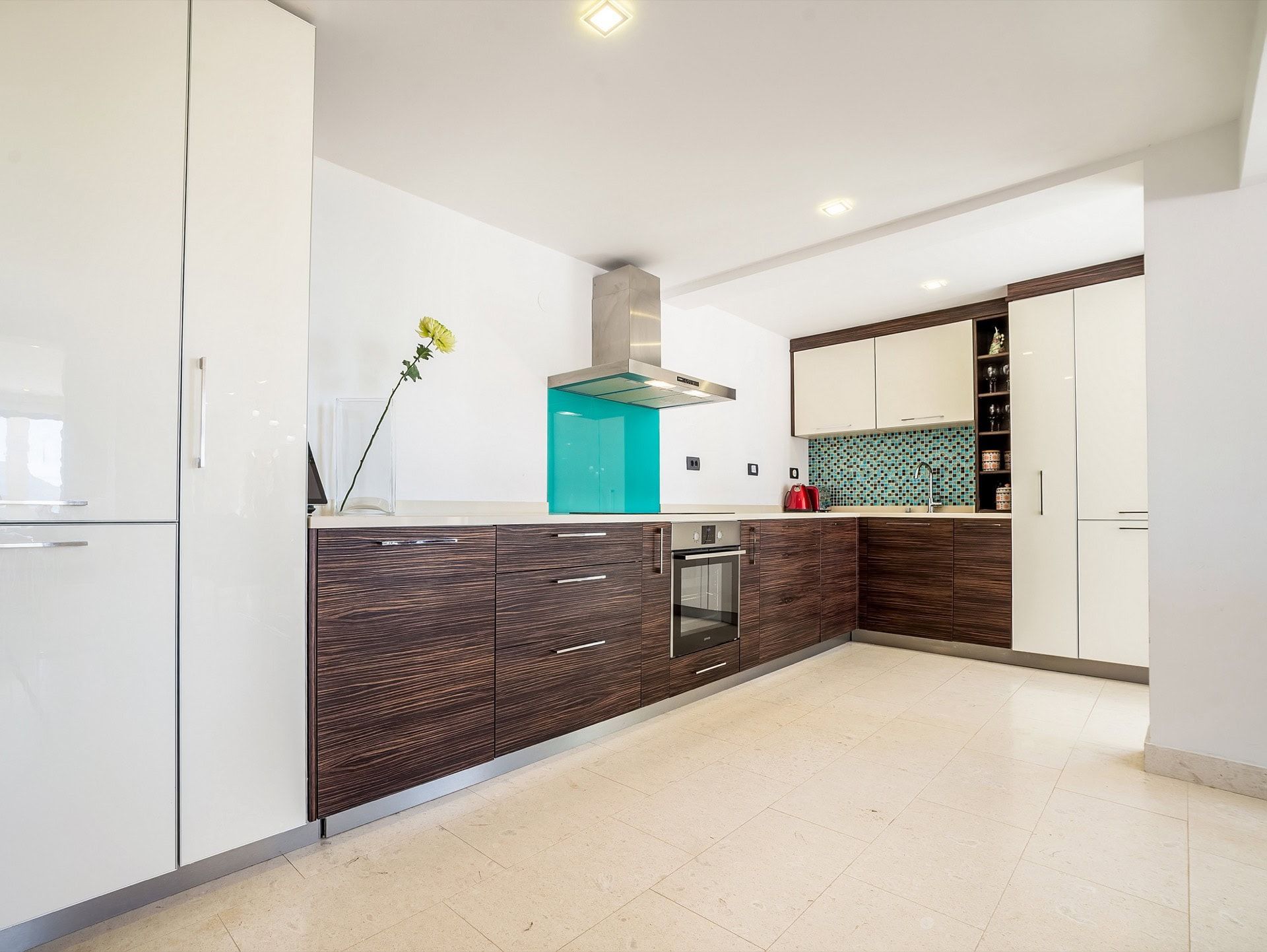Modern kitchen with dark cabinets and a turquoise backsplash in a villa in Zanjice, Herceg Novi, Montenegro.