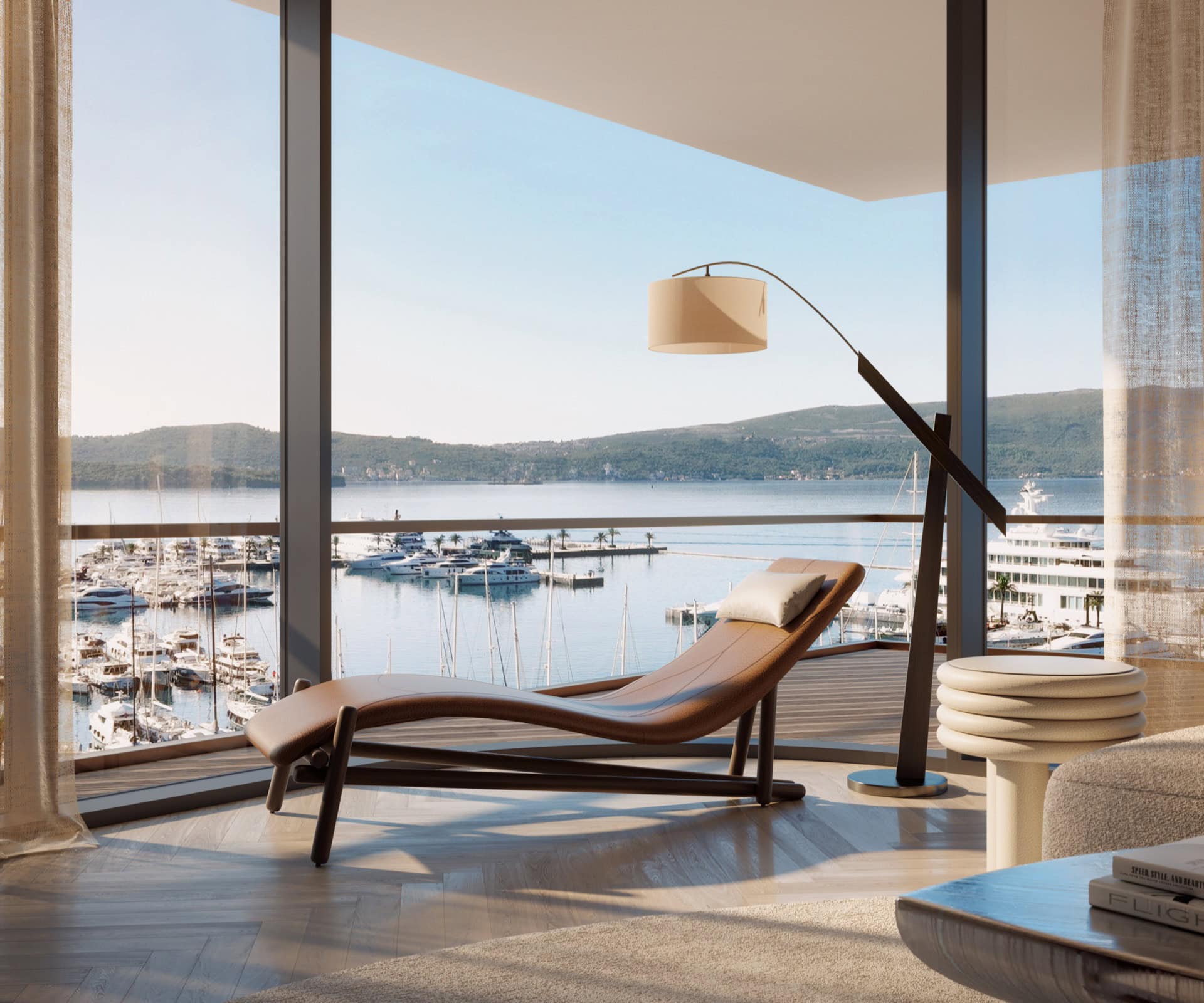 Living room in a premium residence in Tivat, Montenegro: marina view with yachts, leather chaise lounge, and panoramic windows.