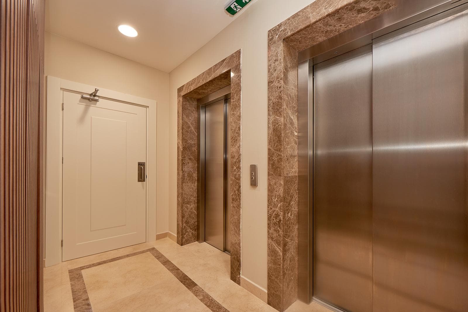 Modern elevator lobby with marble finishes in a residential complex, Becici, Montenegro.