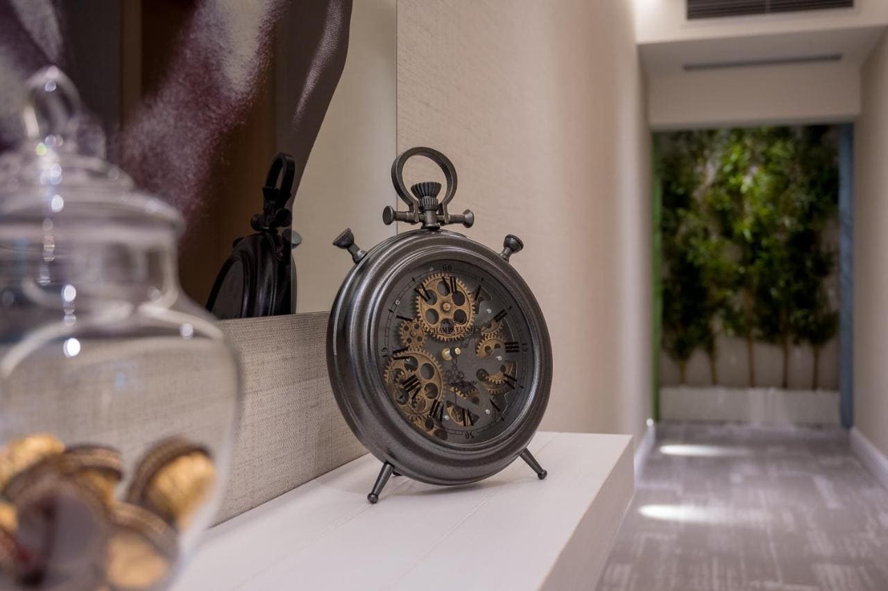 Vintage clock with gears in a hotel interior in Budva, Montenegro: stylish decor and modern room finishes.