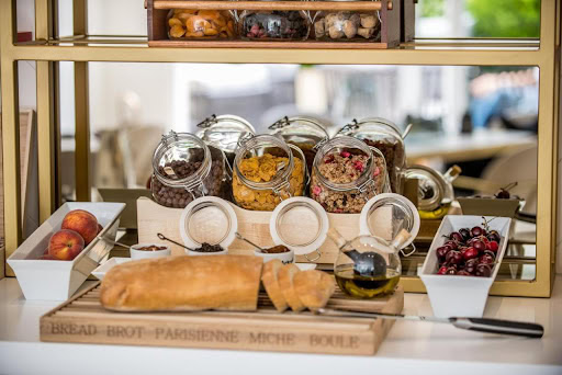 Breakfast at a hotel in Budva, Montenegro: fresh bread, fruit, and cereal on a stylish serving counter in the kitchen area.