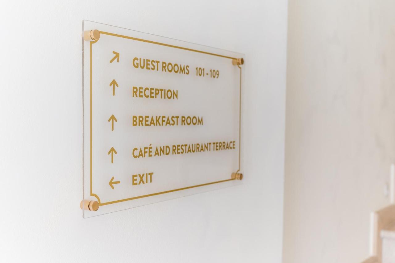 Navigation sign in a hotel in Budva, Montenegro: signs for reception, rooms, restaurant, and exit in the hotel interior.