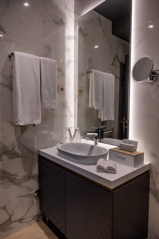 Modern bathroom with marble finishes and lighting in a hotel in Budva, Montenegro.