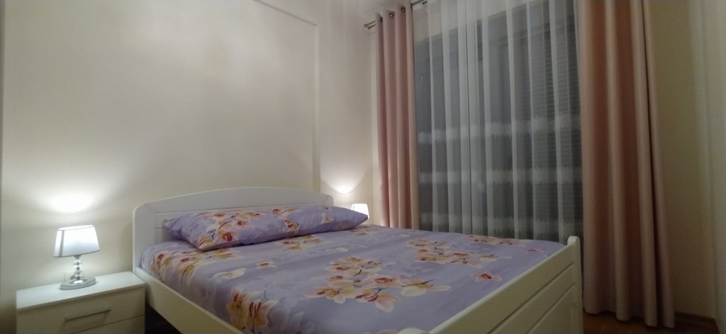 Cozy bedroom with a double bed and bedside table in an apartment for sale, Bečići, Montenegro.