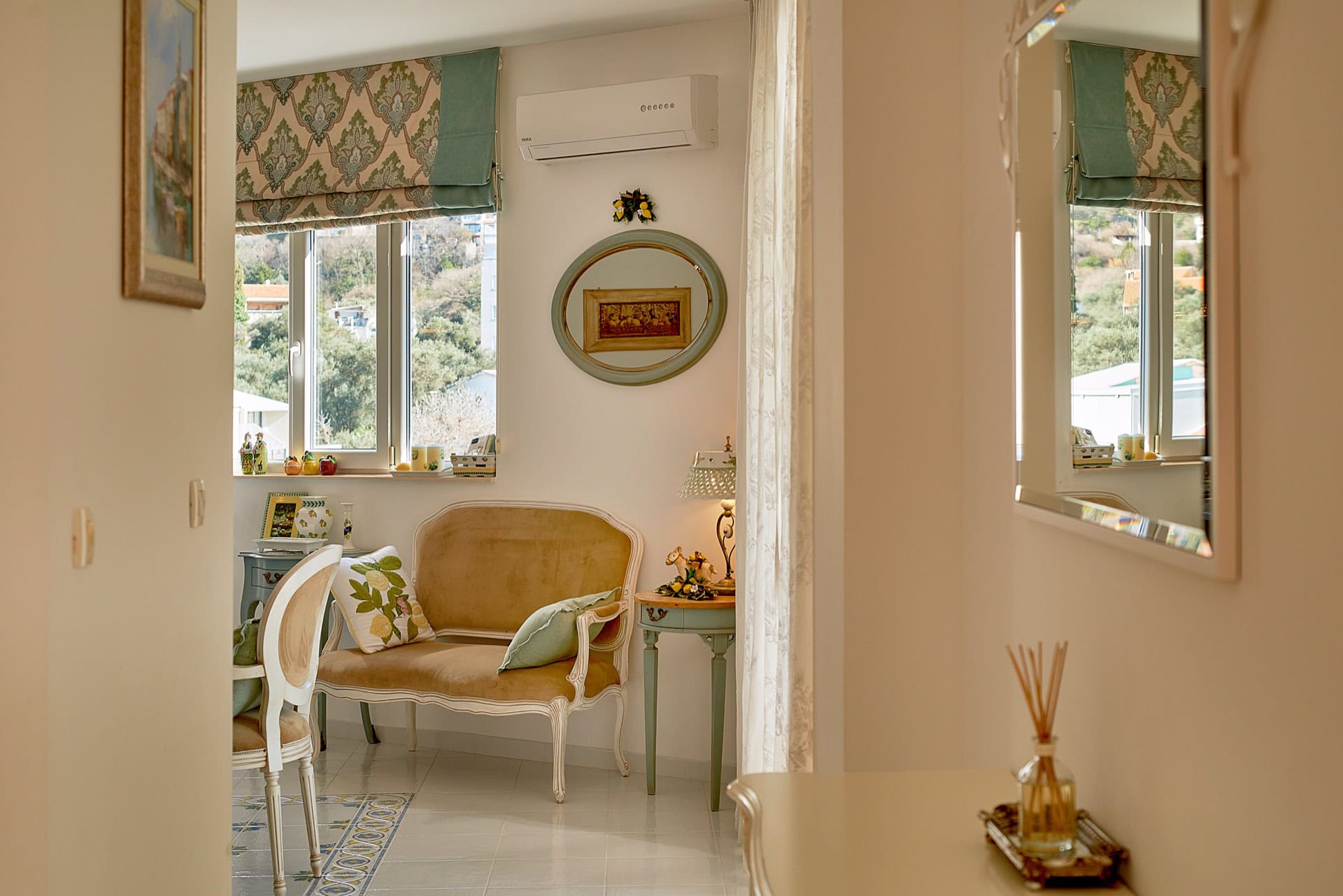 Cozy classic-style living room in a penthouse, Bečići, Montenegro: soft sofa, mountain view, and bright interior.
