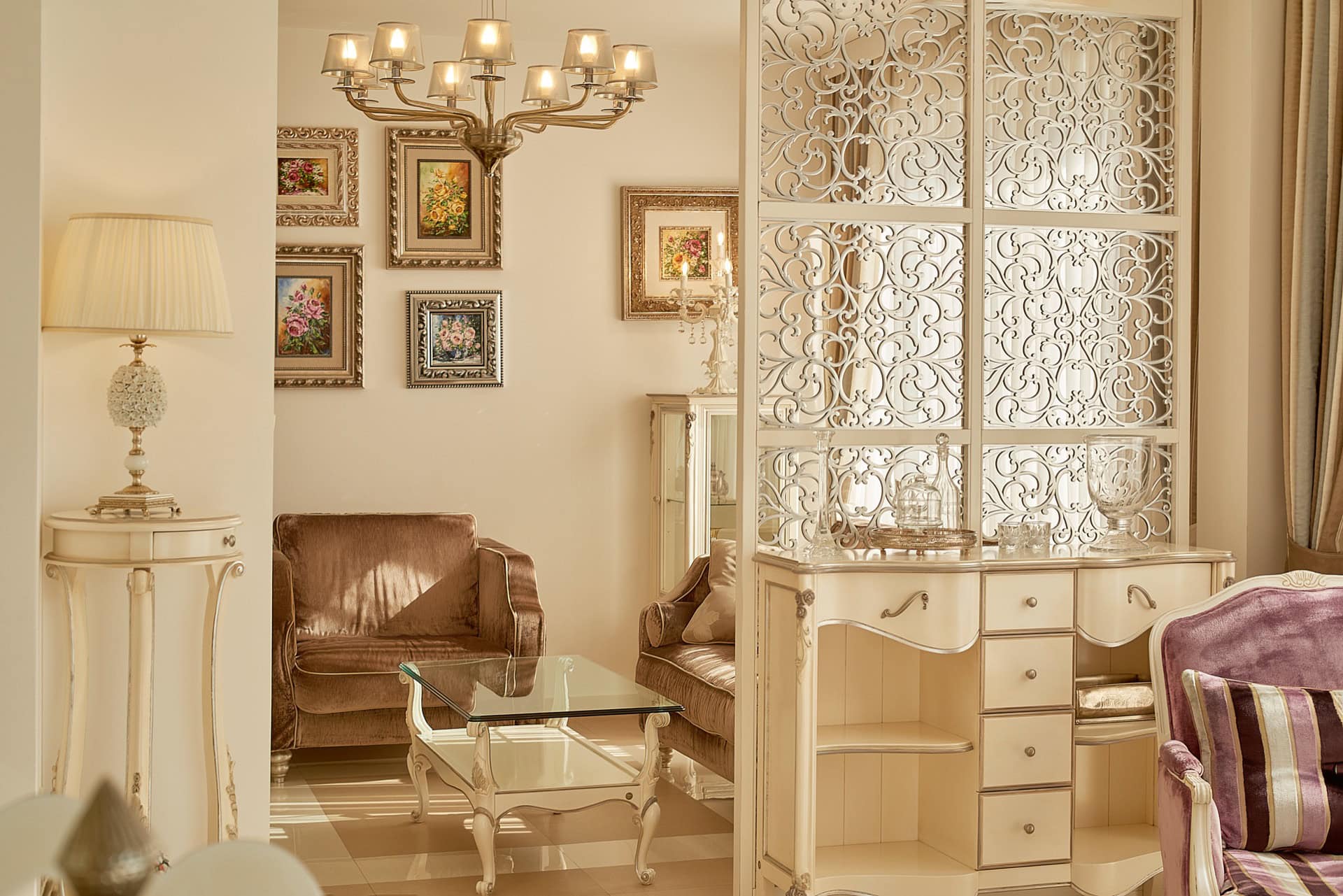 Interior of a classic living room in a penthouse in Bečići, Montenegro: carved partition, upholstered furniture, and decor.