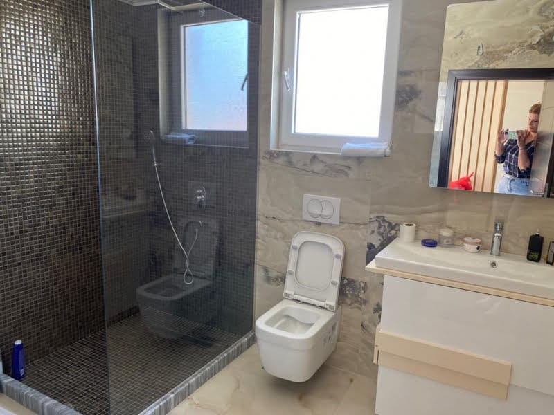 Modern bathroom with a shower cabin and light finishes in a house, Shushan, Montenegro.