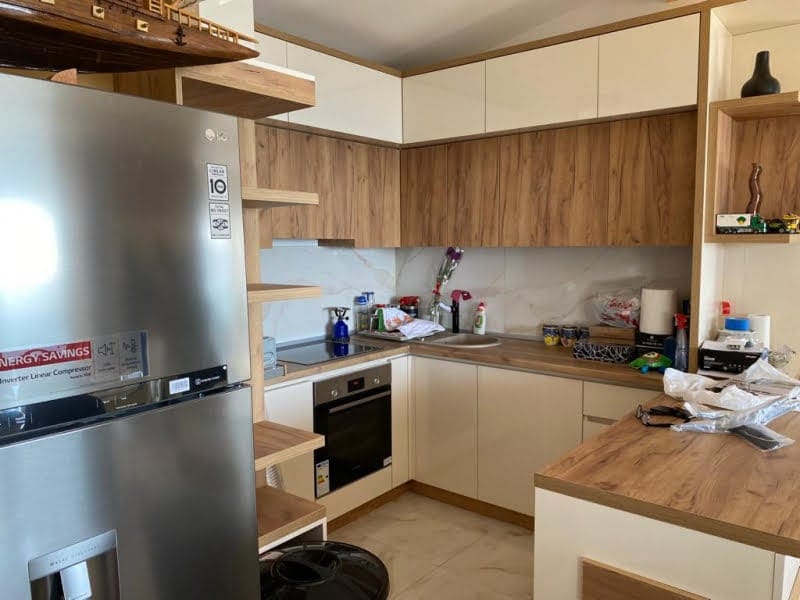 Modern kitchen with wooden fronts and built-in appliances in a house, Shushan, Montenegro.
