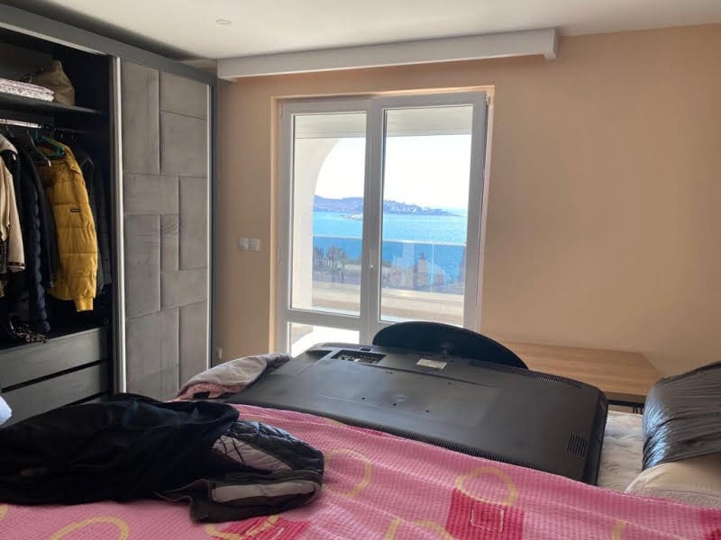 Bedroom in a house in Shushan, Montenegro: built-in wardrobe, bed, and panoramic sea view from the window.