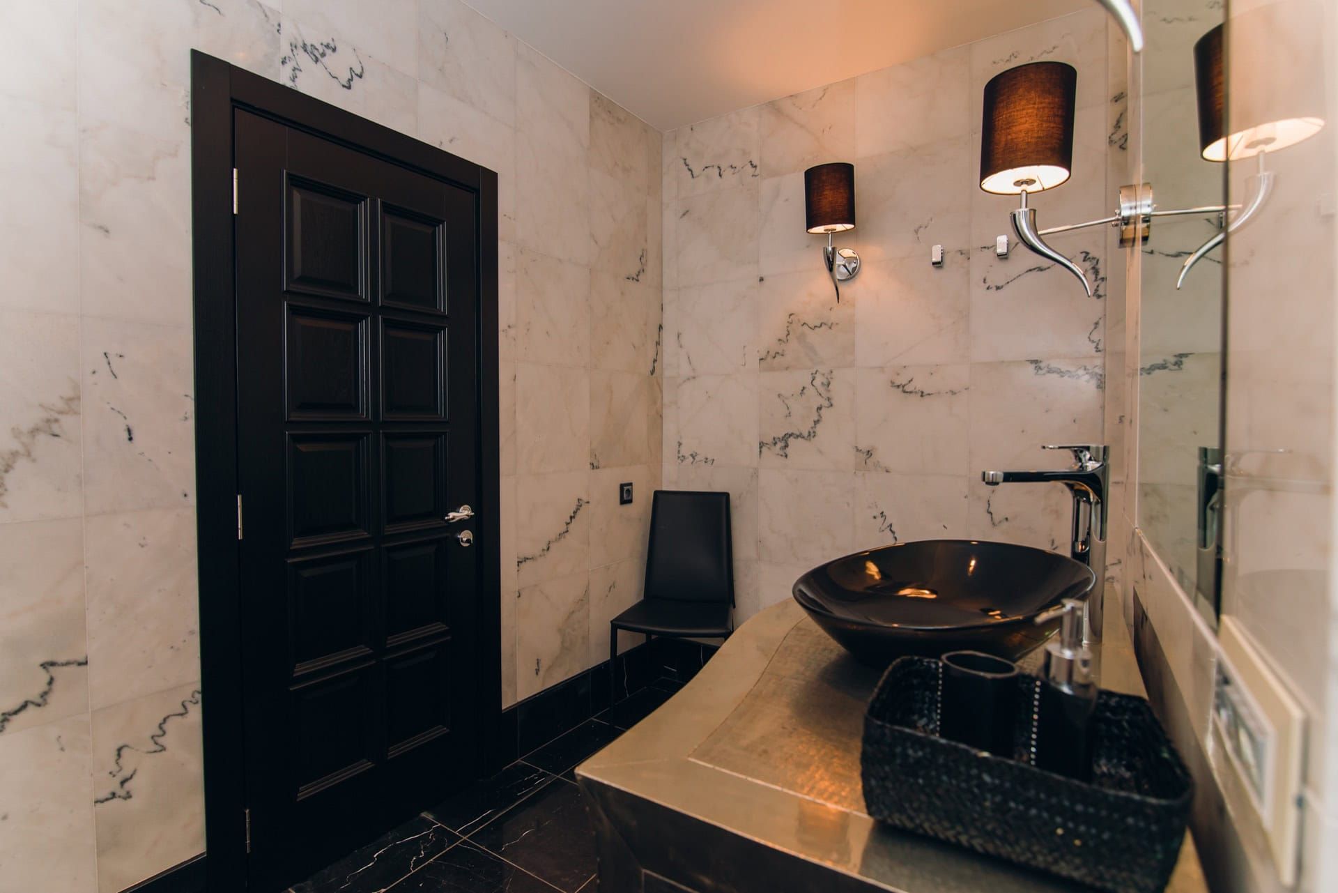 Modern bathroom with marble finishes and black furniture in a villa in Reževići, Montenegro.