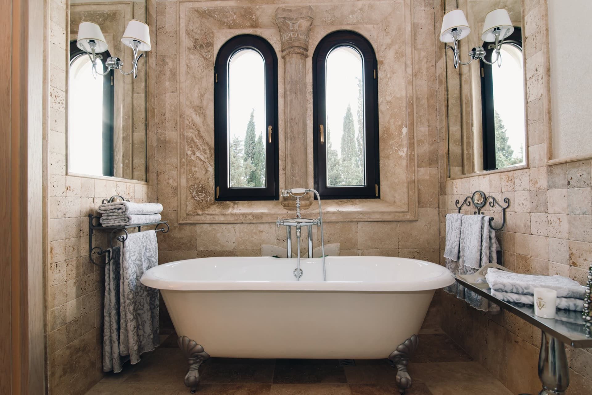 Luxurious bathroom with a freestanding bathtub and travertine finishes in a villa in Reževići, Montenegro.