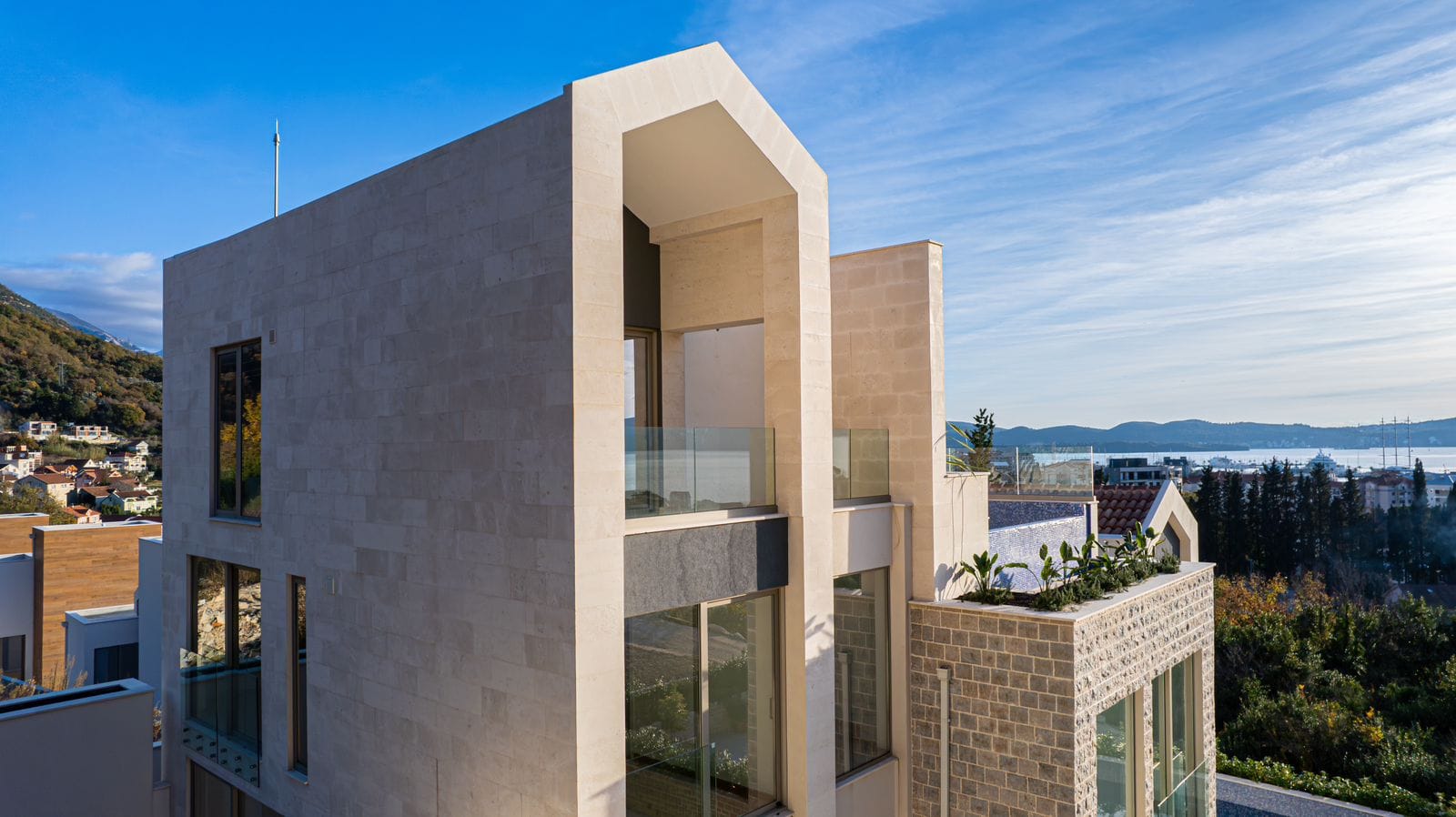 Modern villa with a stone facade, terraces, and sea views in Tivat, Montenegro. Luxury property.