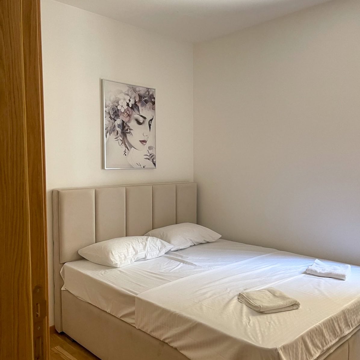 Cozy bedroom with a double bed in an apartment in Bečići, Montenegro: bright interior and stylish decor.