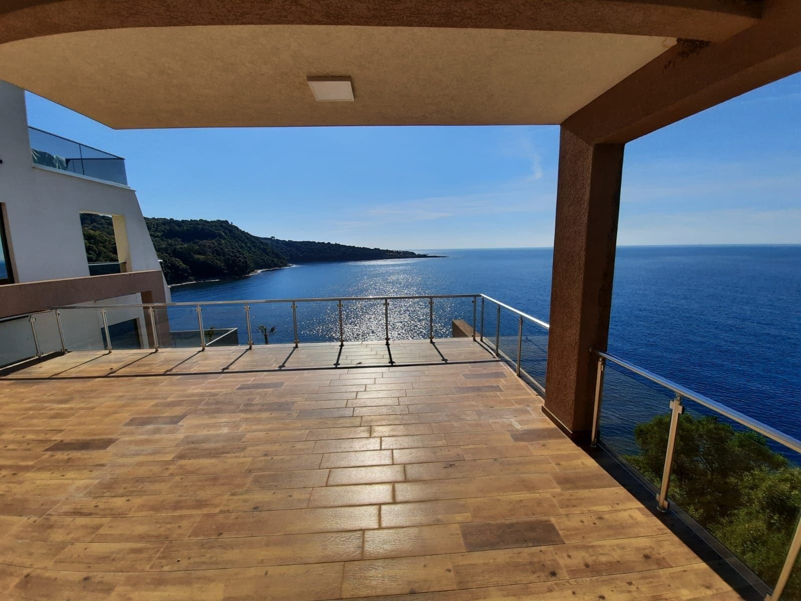 Spacious terrace with panoramic sea and mountain views, villa in Dobra Voda, Kruče, Montenegro, modern finishes.