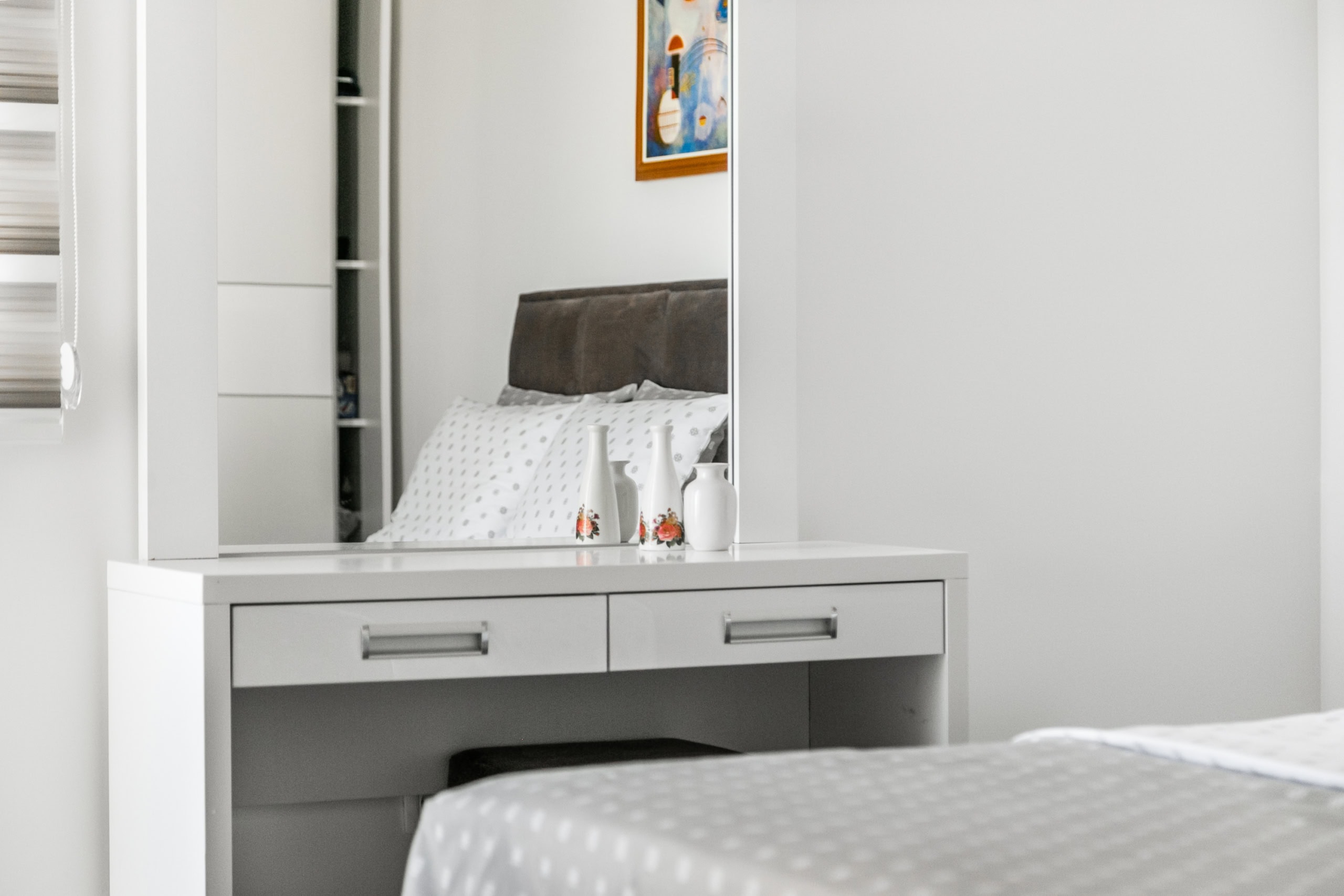 White vanity table with mirror in the bedroom interior of an apartment in Seoce, Budva, Montenegro.