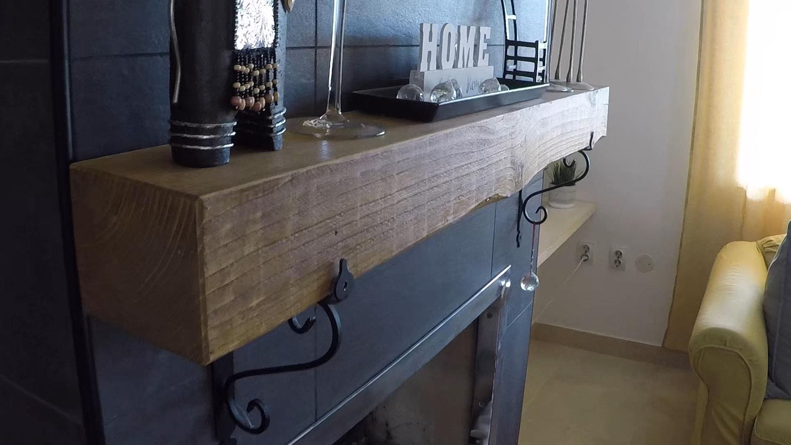 Fireplace with a wooden mantel in the living room of a house in Krimovica, Montenegro, stylish decor and tiled finish.