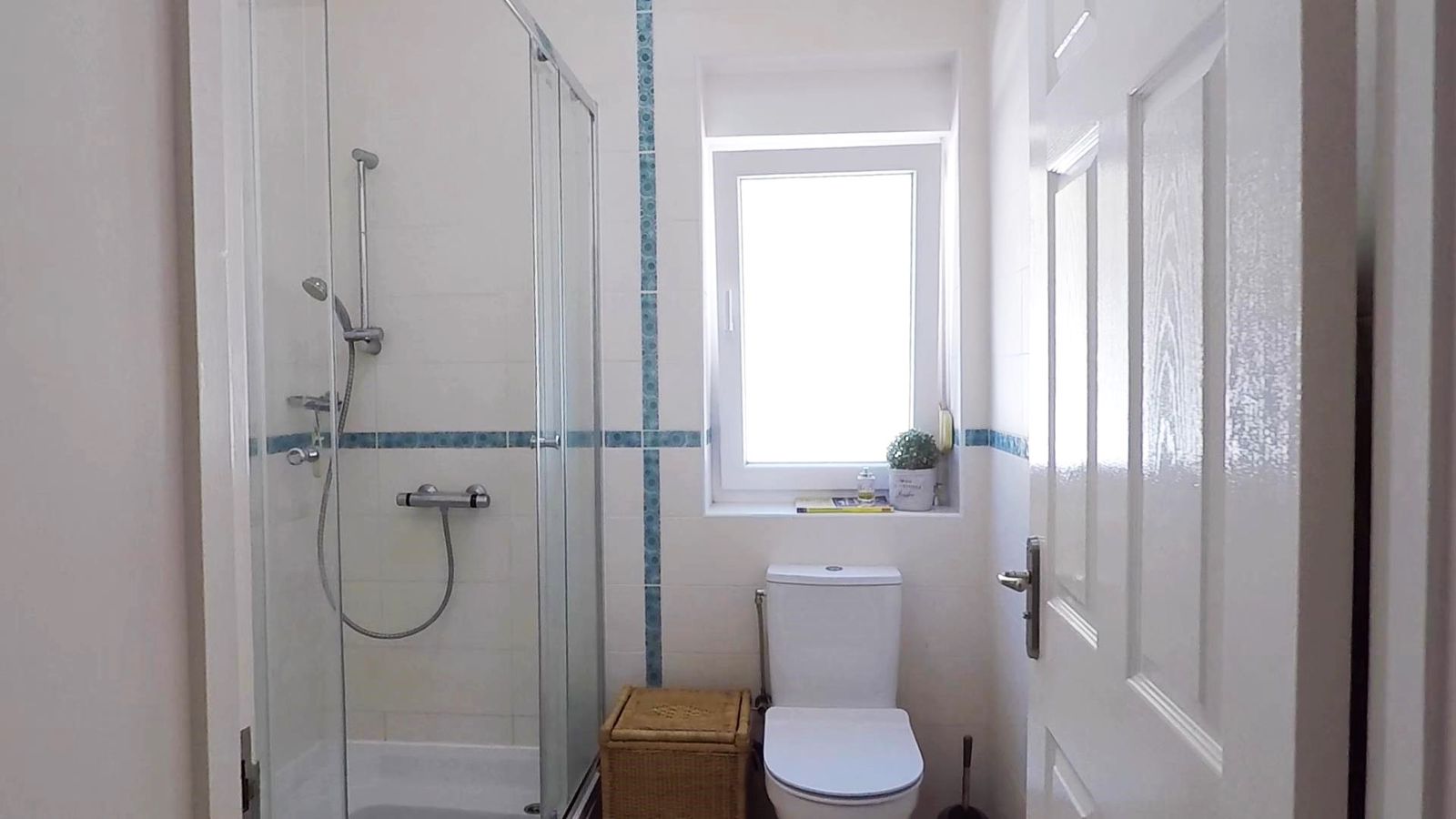 Bright bathroom with a shower cabin and a window in a house, Krymovitsa village, Montenegro. Modern plumbing.