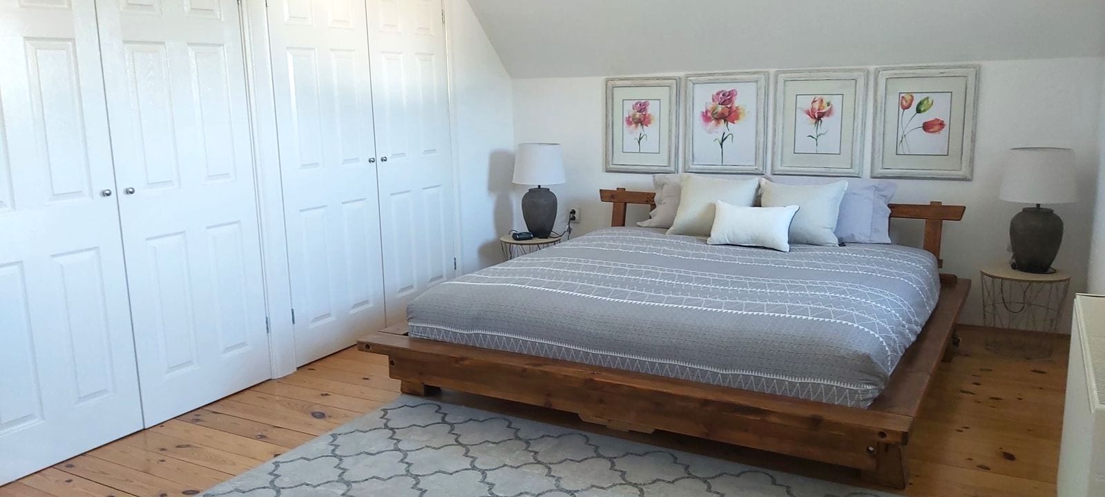Cozy bedroom with a wooden bed and a bright interior in a house, Krumovica, Montenegro.