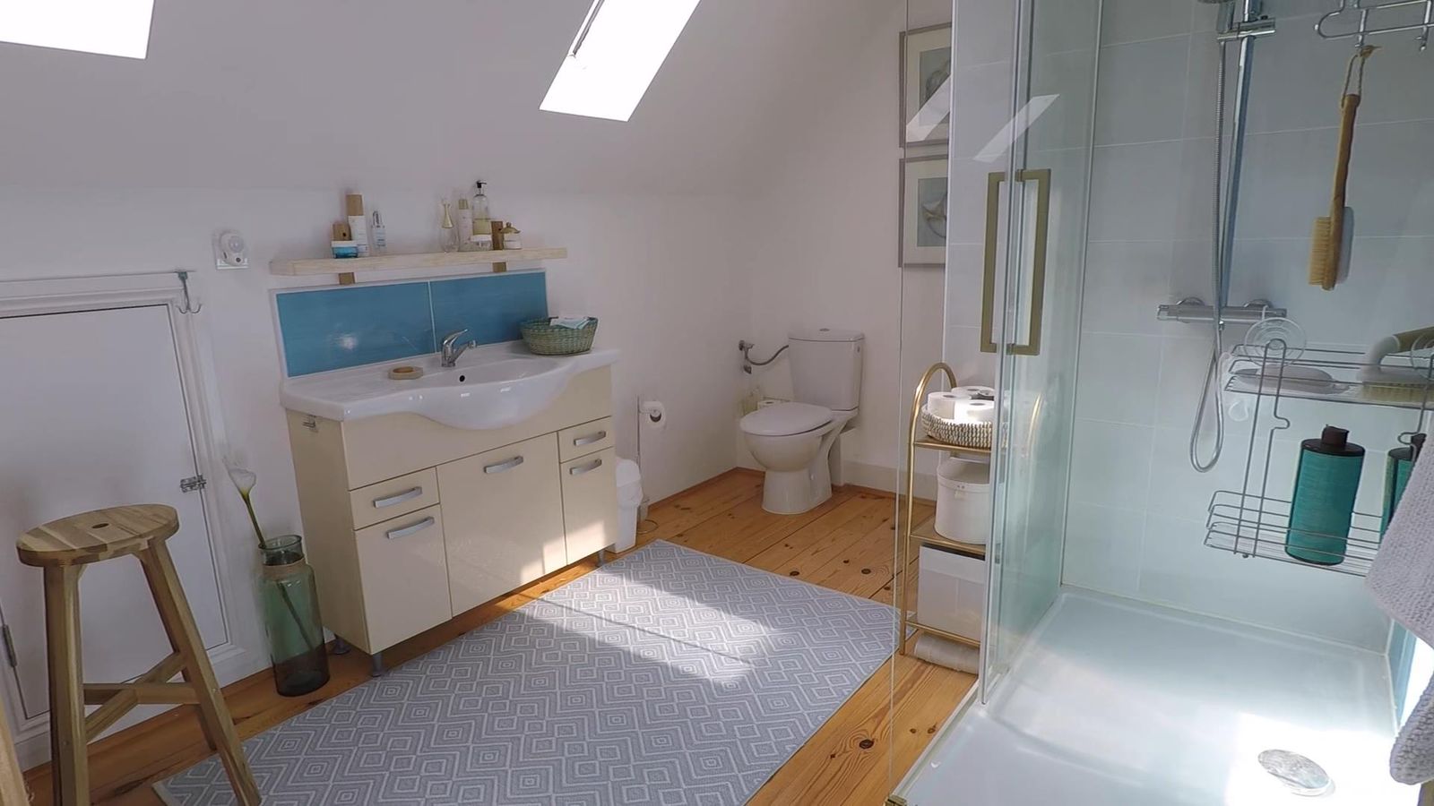 Bright bathroom in a house in Krimovica, Montenegro: shower cabin, vanity with sink, and a skylight.