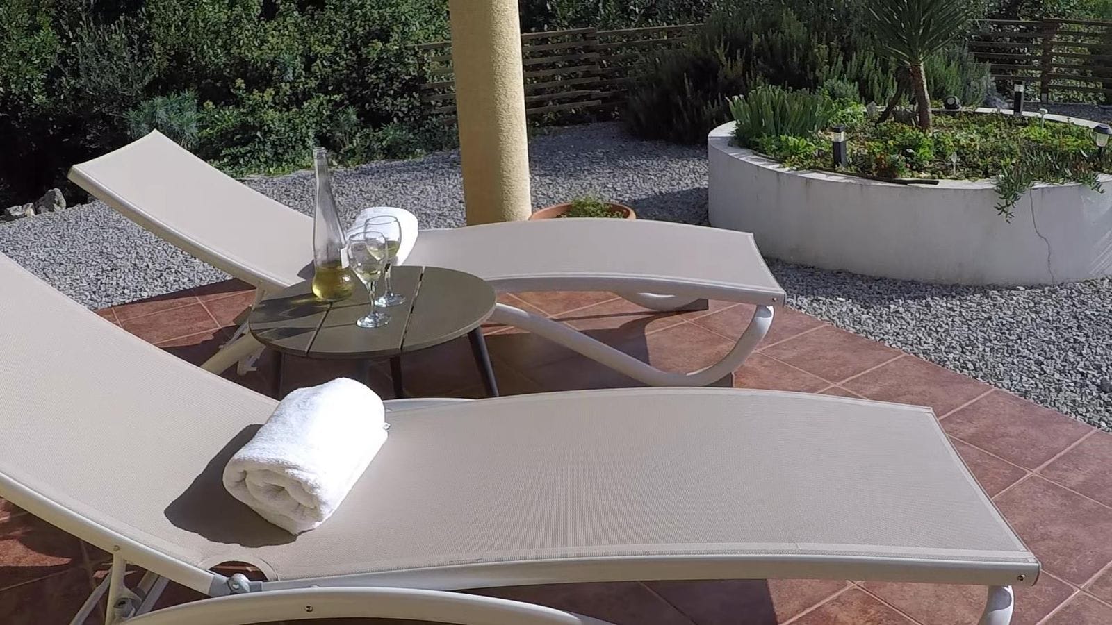 Sun loungers on the terrace of a house in Krimovica, Montenegro: a relaxation area with garden furniture and views of the landscaped grounds.